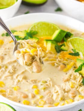 A Spoon Scooping out a Bite of White Chicken Chili From a Bowl