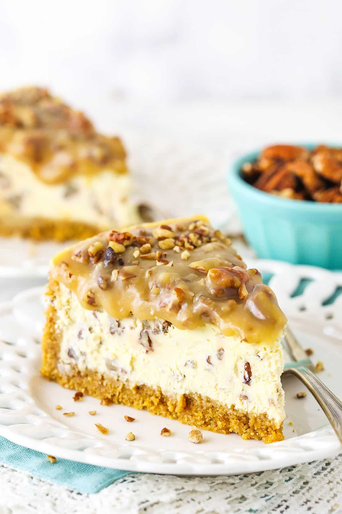 slice of pecan praline cheesecake on white plate