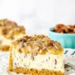 slice of pecan praline cheesecake with another slice in background