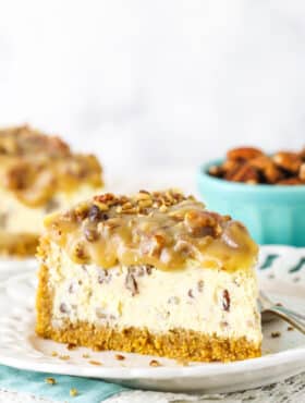 slice of pecan praline cheesecake with another slice in background