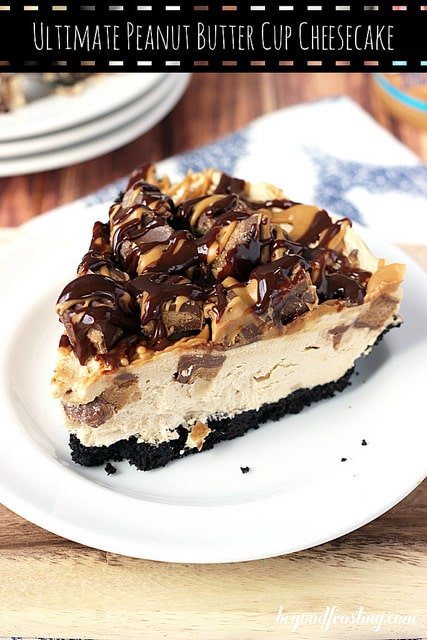 A Big Piece of Peanut Butter Cup Cheesecake on a Plate at the Edge of the Table