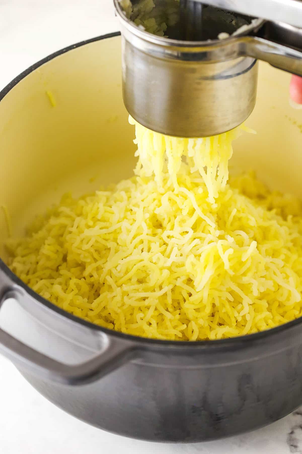 Step 4 add the chopped potatoes to a potato ricer and rice them into a large pot 