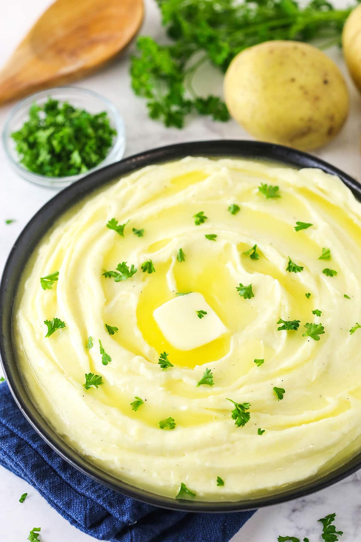 Creamy mashed potatoes in black bowl