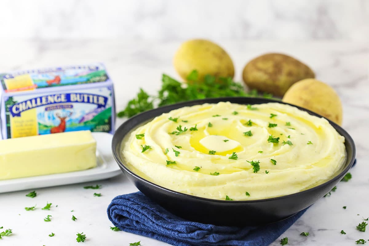 mashed potatoes with butter in background