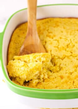 A Wooden Spoon Scooping out a Serving of Creamy Cornbread Casserole