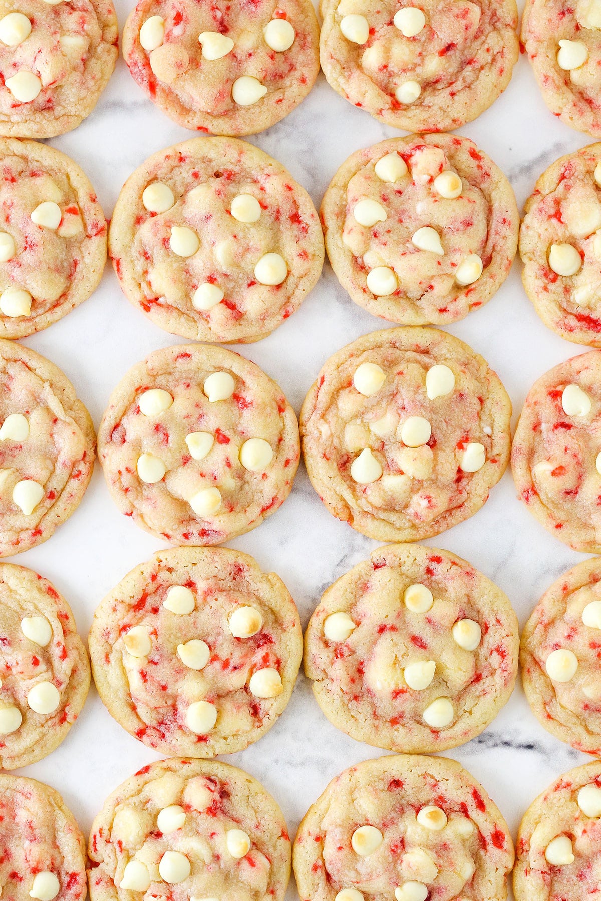 Peppermint sugar cookies neatly arranged on a granite countertop.