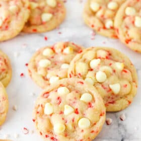 Peppermint Sugar Cookies Grouped Together on the Counter with Crushed Peppermint Pieces