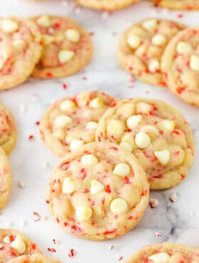 Peppermint Sugar Cookies Grouped Together on the Counter with Crushed Peppermint Pieces