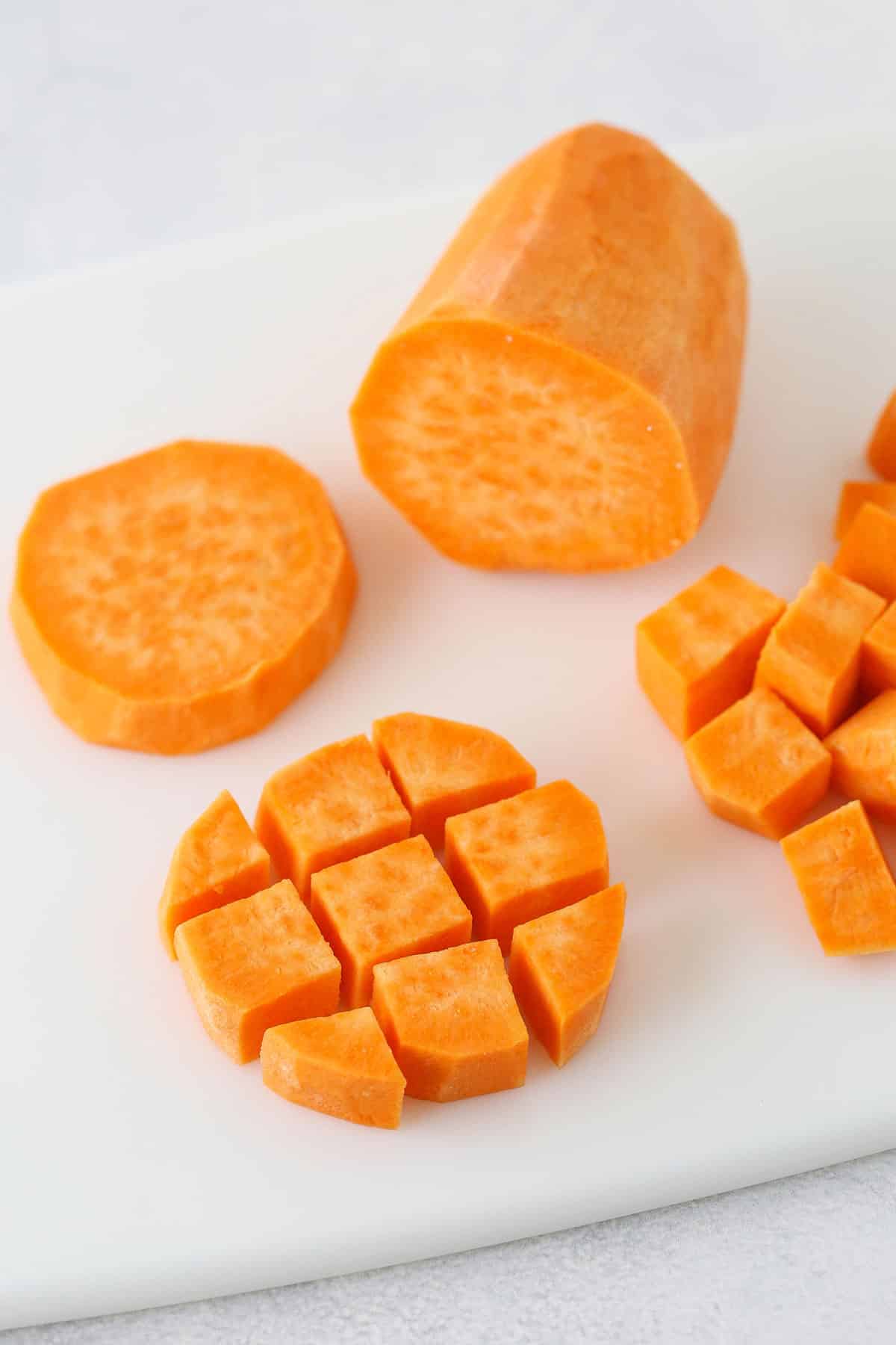 Half Inch Cubes of a Peeled Sweet Potato on a Cutting Board