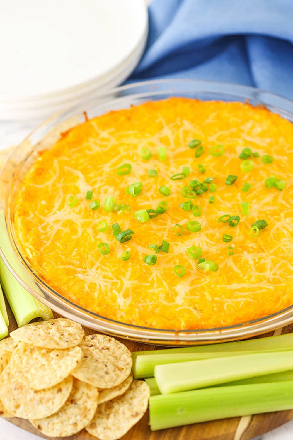 A Bowl of Buffalo Chicken Dip Beside a Pile of Crackers and a Stack of Celery