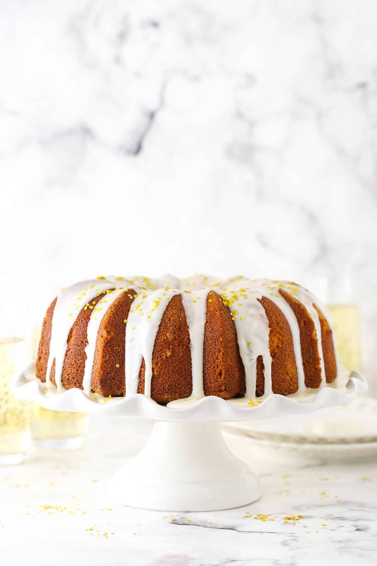 A Champagne Pound Cake on a Cake Stand From the Side.