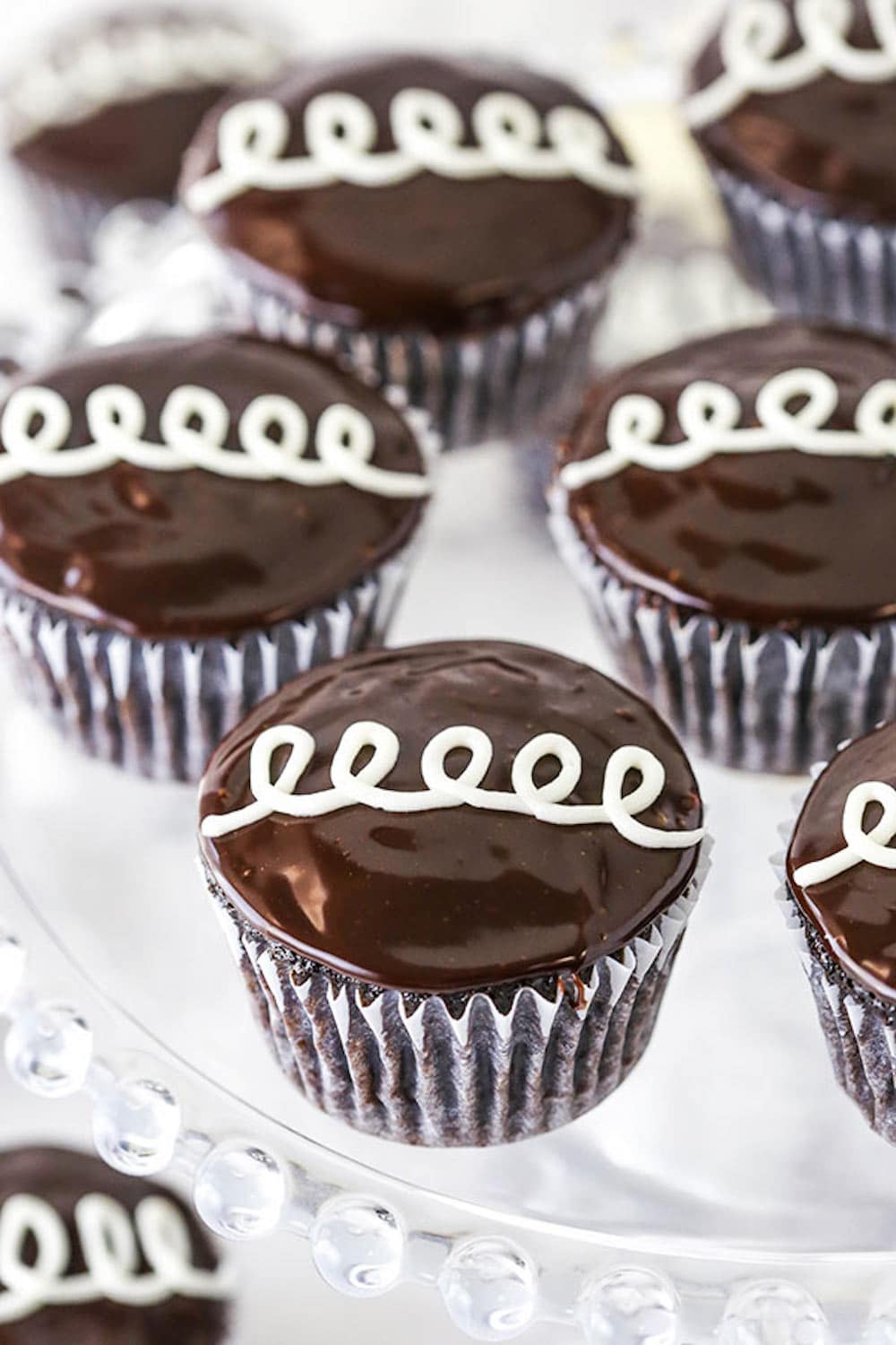 A Cake Stand Holding Half a Batch of Homemade Hostess Cupcakes.