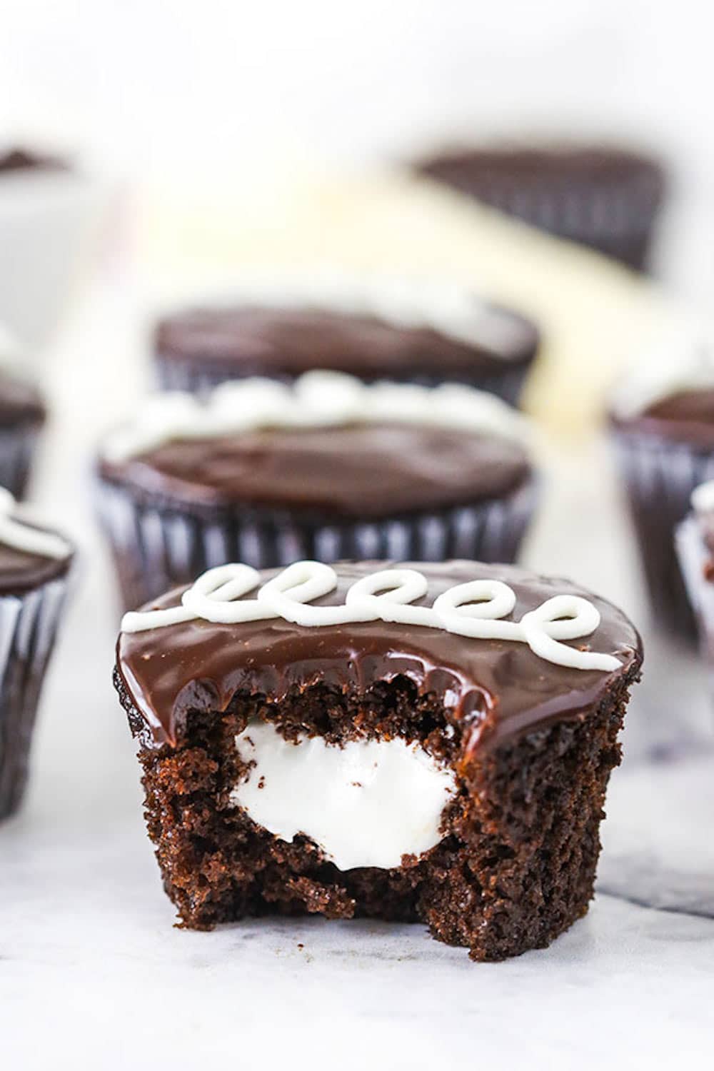 A Bitten Hostess Cupcake with Marshmallow Filling in the Middle.