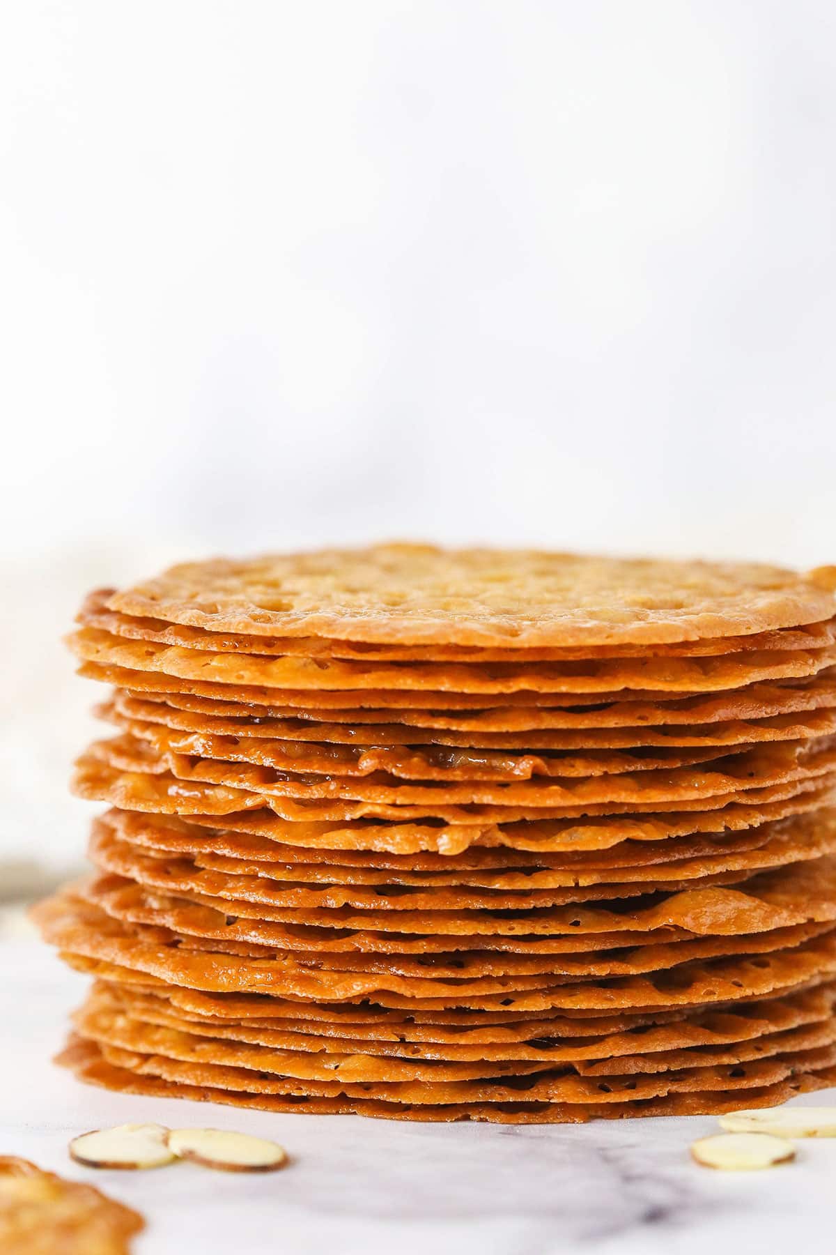 A Pile of Crispy Caramel Cookies on a Granite Countertop