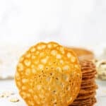 A Single Lace Cookie Propped Up Against a Stack of More Cookies