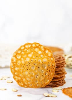 A Single Lace Cookie Propped Up Against a Stack of More Cookies