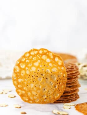A Single Lace Cookie Propped Up Against a Stack of More Cookies