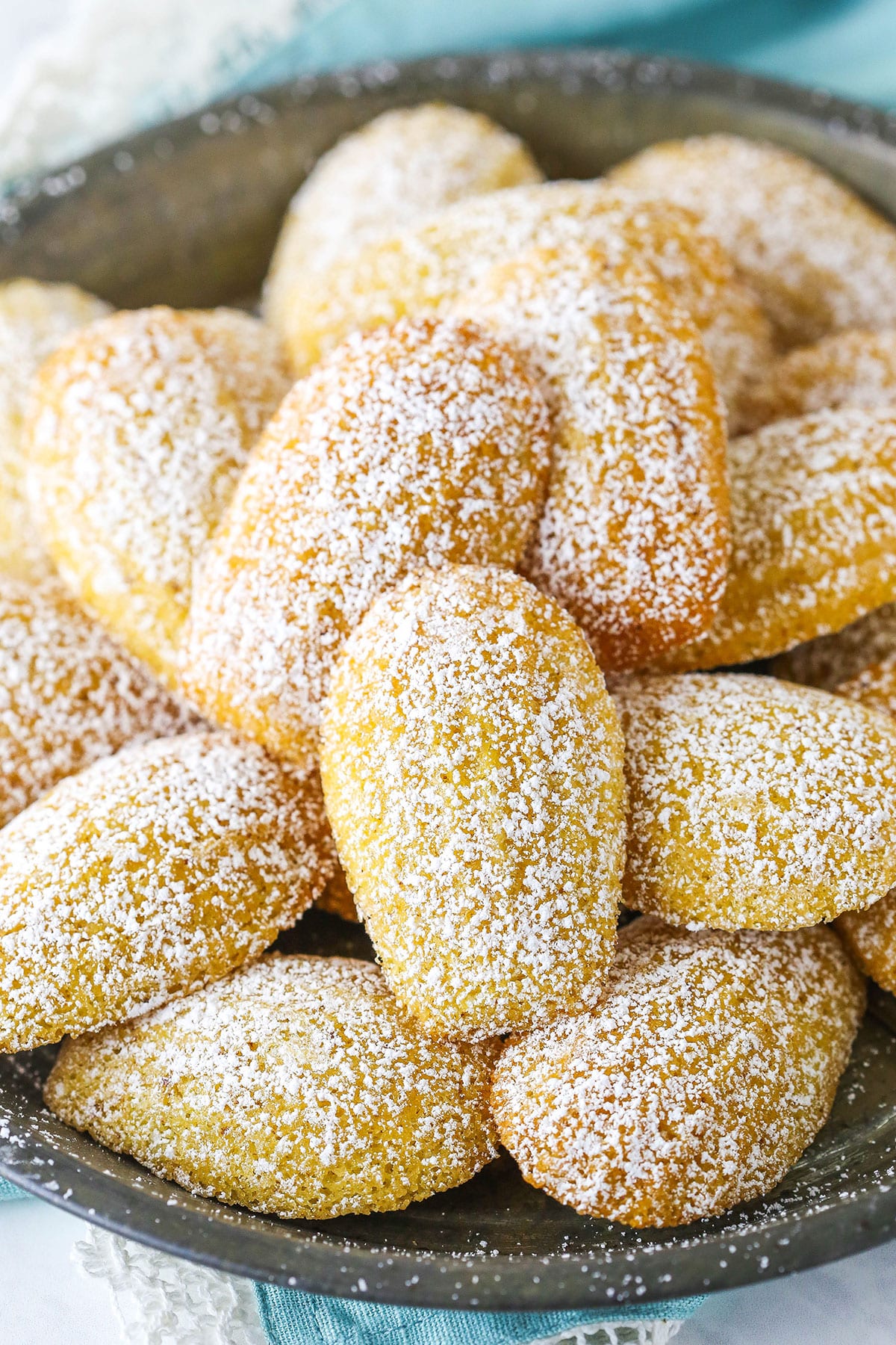 A Big Green Bowl Piled with Sugar Dusted Madeleines.