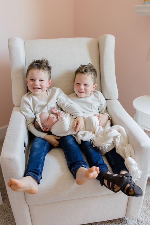 Boys sitting in chair holding McKenzie