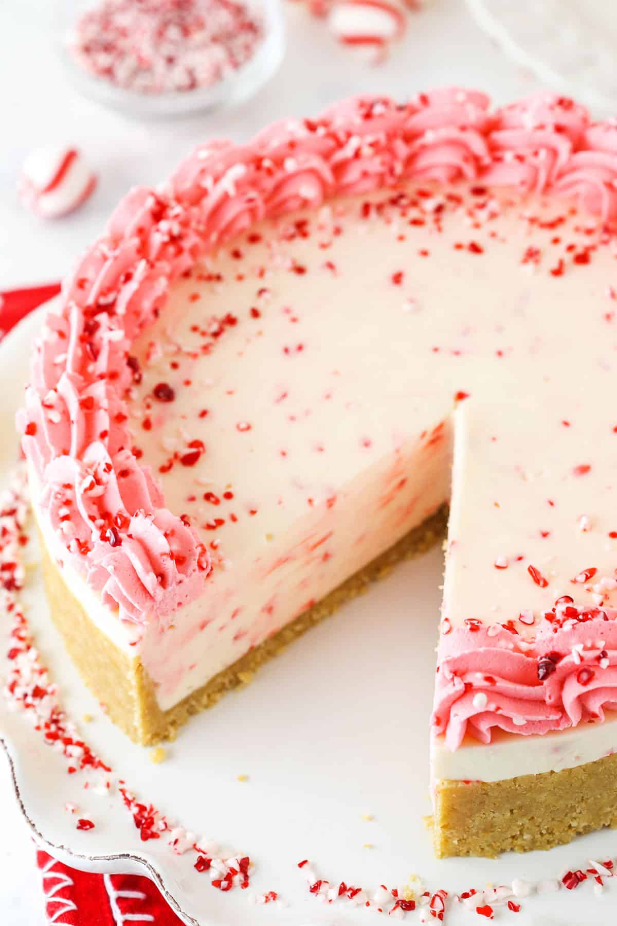 A Peppermint Cheesecake on a Plate with One Slice Missing.