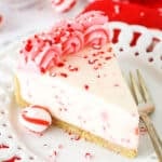 A Slice of Peppermint Cheesecake on a White Plate with a Dessert Fork.