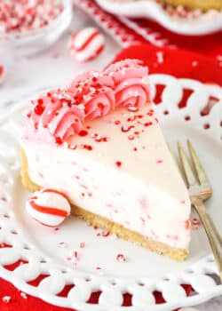 A Slice of Peppermint Cheesecake on a White Plate with a Dessert Fork.