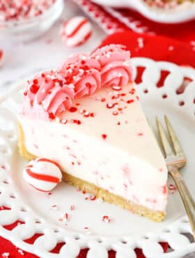 A Slice of Peppermint Cheesecake on a White Plate with a Dessert Fork.