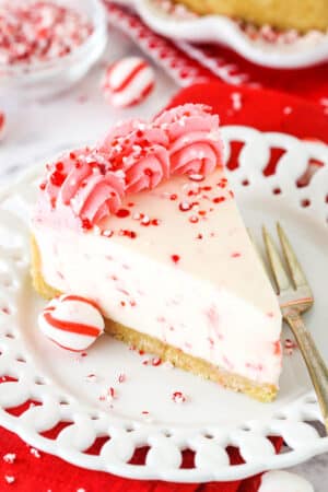 A Slice of Peppermint Cheesecake on a White Plate with a Dessert Fork.