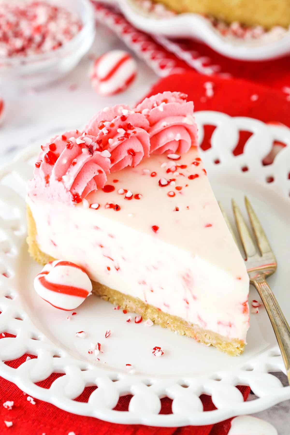 No Bake Peppermint Cheesecake A Slice of Peppermint Cheesecake on a White Plate with a Dessert Fork.