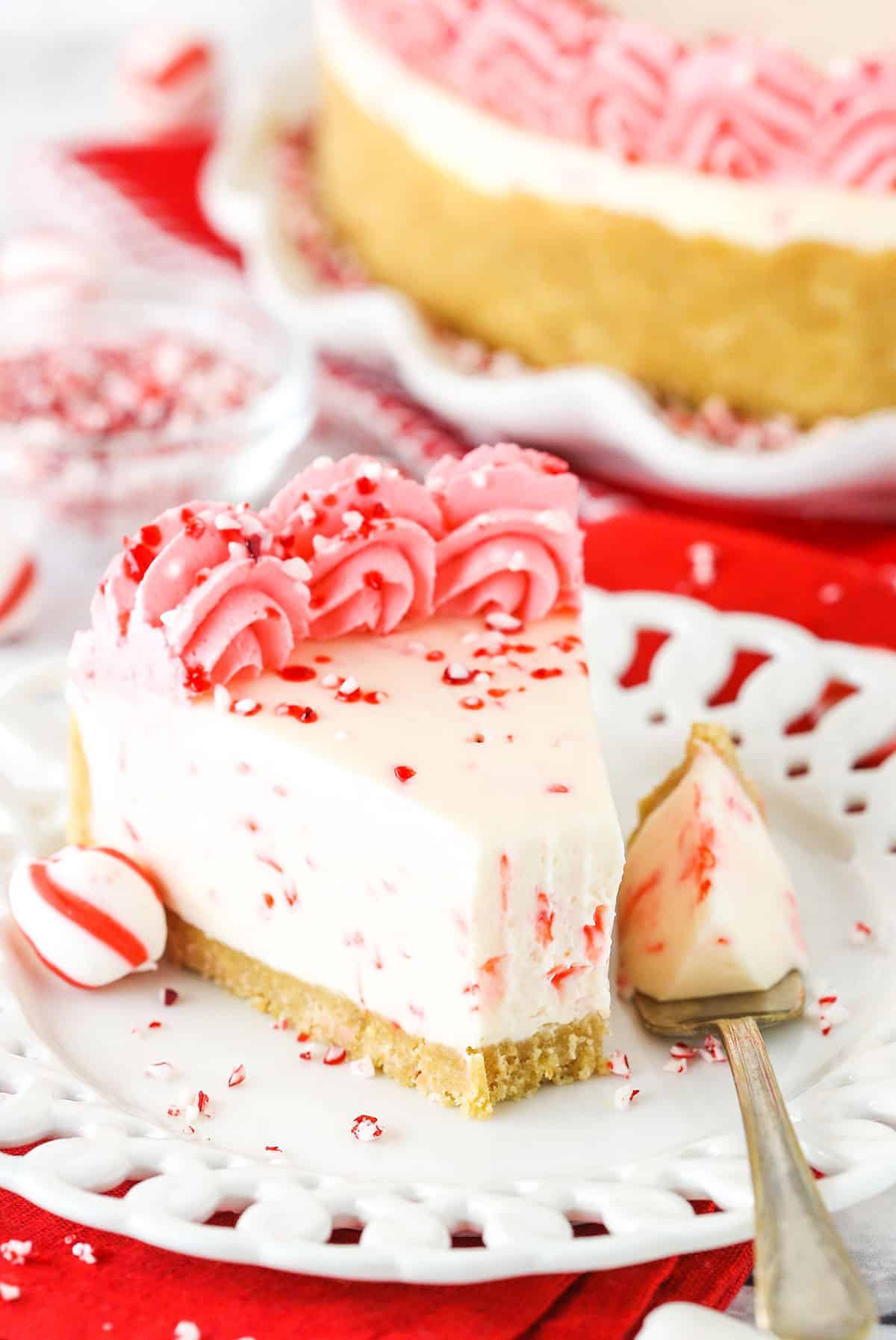 A Slice of Peppermint Cheesecake with One Bite on a Fork