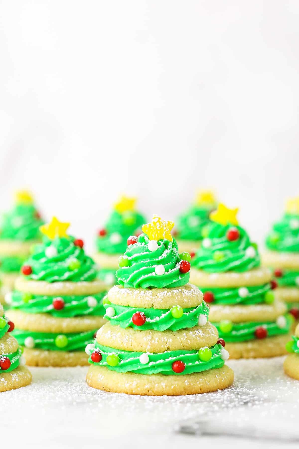 Sugar cookie Christmas trees with powdered sugar.