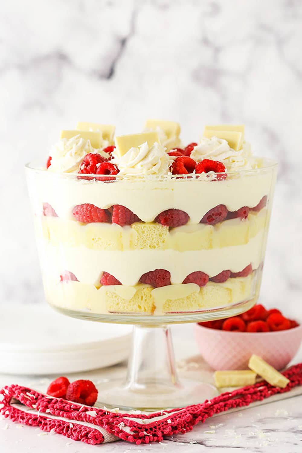 A White Chocolate Raspberry Trifle in a Clear Dish on Top of a Cloth Napkin