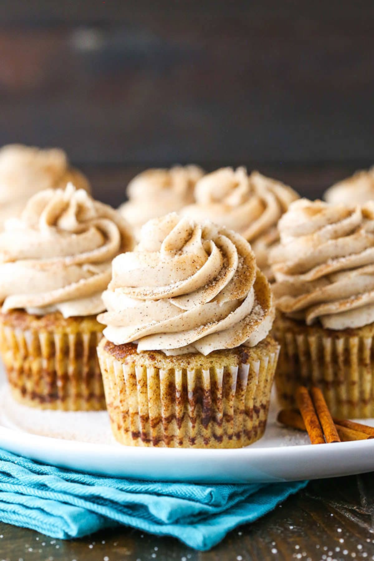 A White Plate Full of Cinnamon Sugar Swirl Cupcakes with Cinnamon Frosting