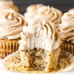 A Cinnamon Roll Cupcake on a Plate with One Bite Taken Out