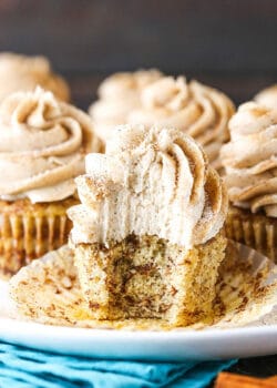 A Cinnamon Roll Cupcake on a Plate with One Bite Taken Out