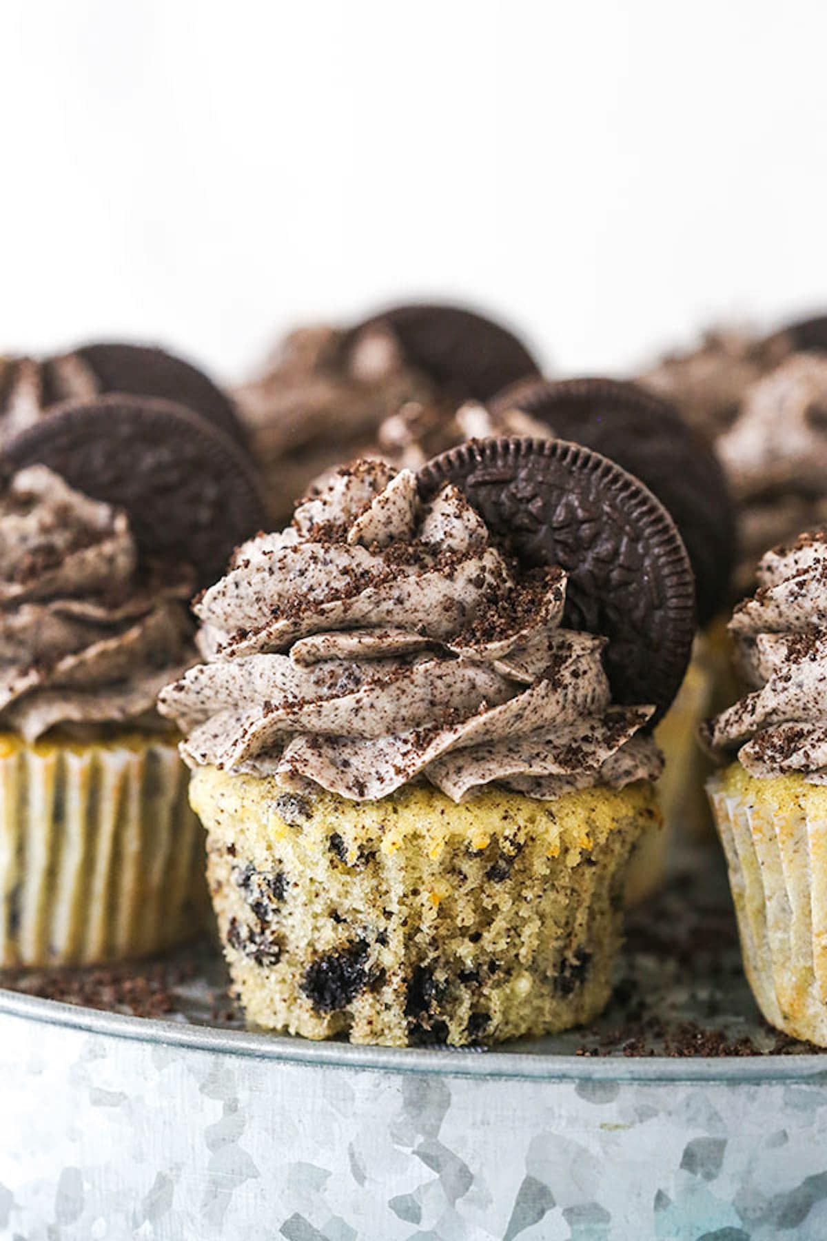 A plate of Oreo Cupcakes garnished with half Oreos and Oreo frosting. 