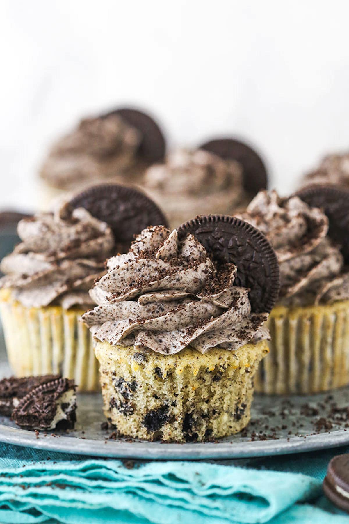 Six Cookies and Cream Cupcakes on a silver cake stand.