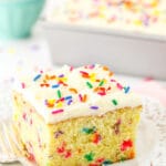 A Slice of Confetti Cake on a Plate with a Lace-Patterned Border