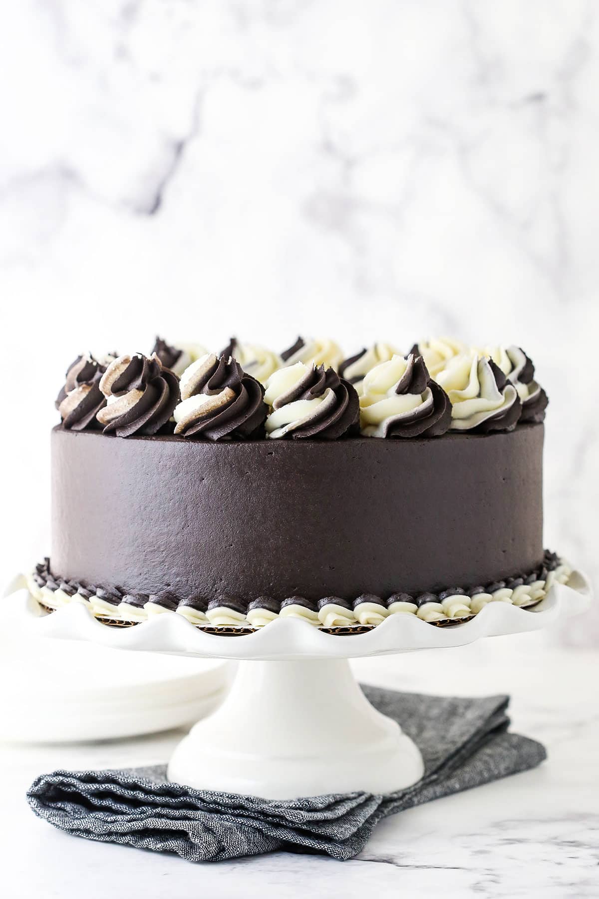 A Fully Decorated Zebra Cake on Top of a White Cake Stand