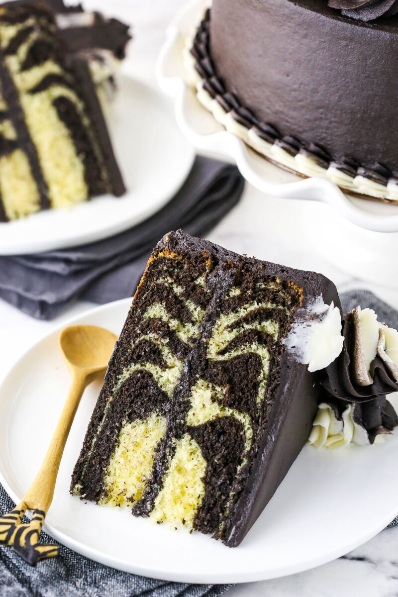 A Large Slice of Double-Layer Zebra Cake on a White Plate