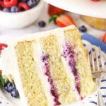 A Piece of Chantilly Layer Cake on a Plate with Fresh Berries