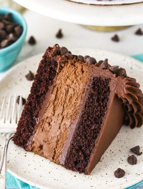 A Piece of Chocolate Cheesecake on a White and Tan Speckled Plate