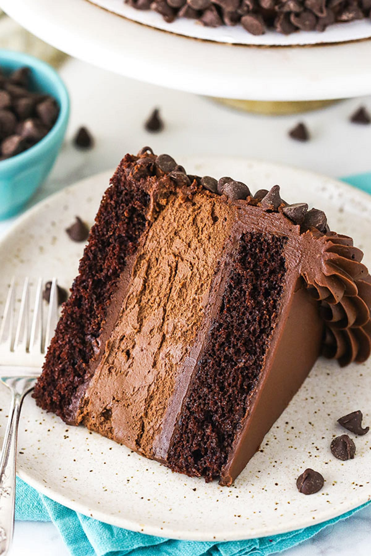 A Piece of Chocolate Cheesecake on a White and Tan Speckled Plate