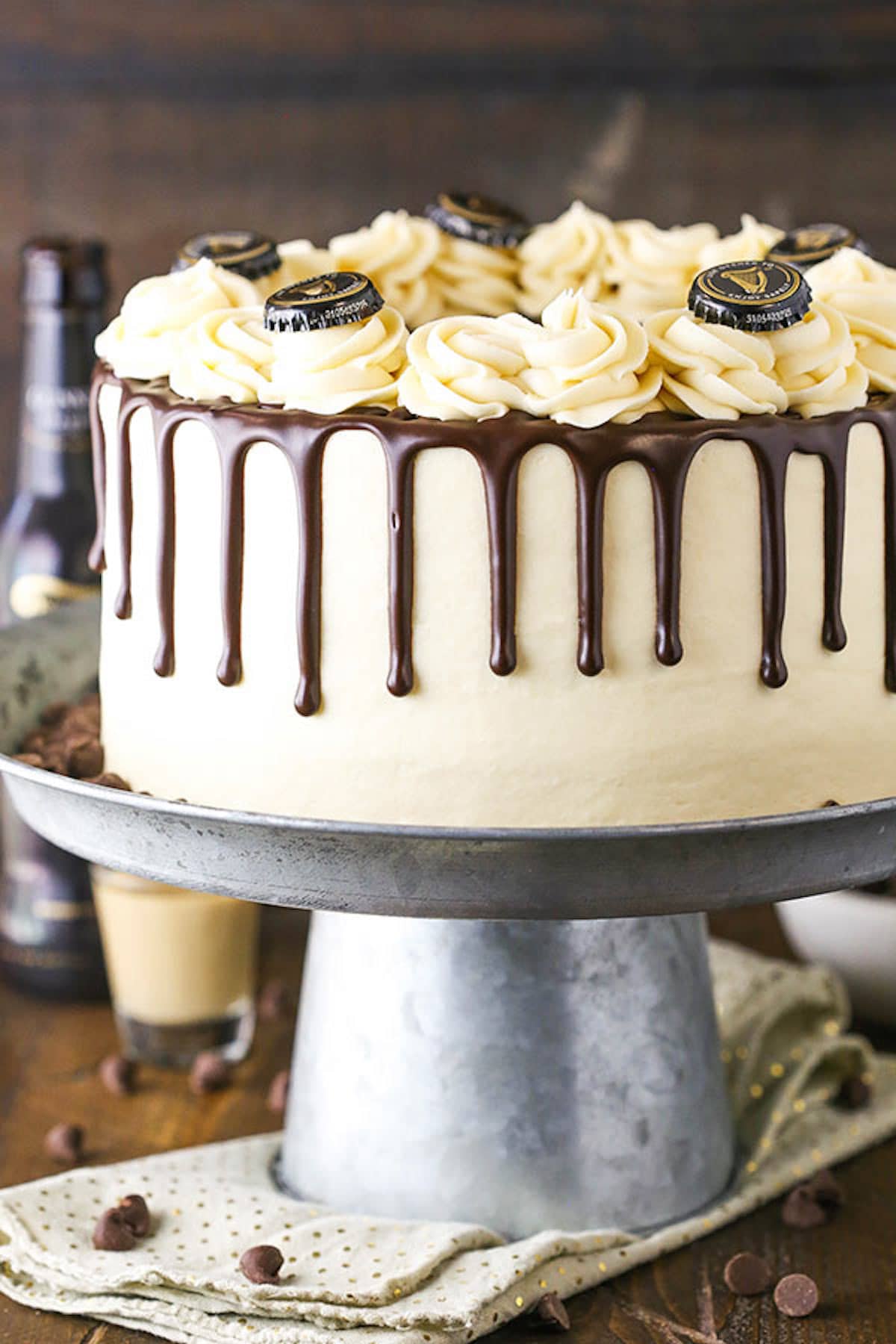 A Guinness Cake with a Chocolate Ganache Drip Design on a Cake Stand