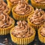 A Plate Full of Mini Coffee Cheesecakes Garnished with Crushed Chocolate Covered Espresso Beans