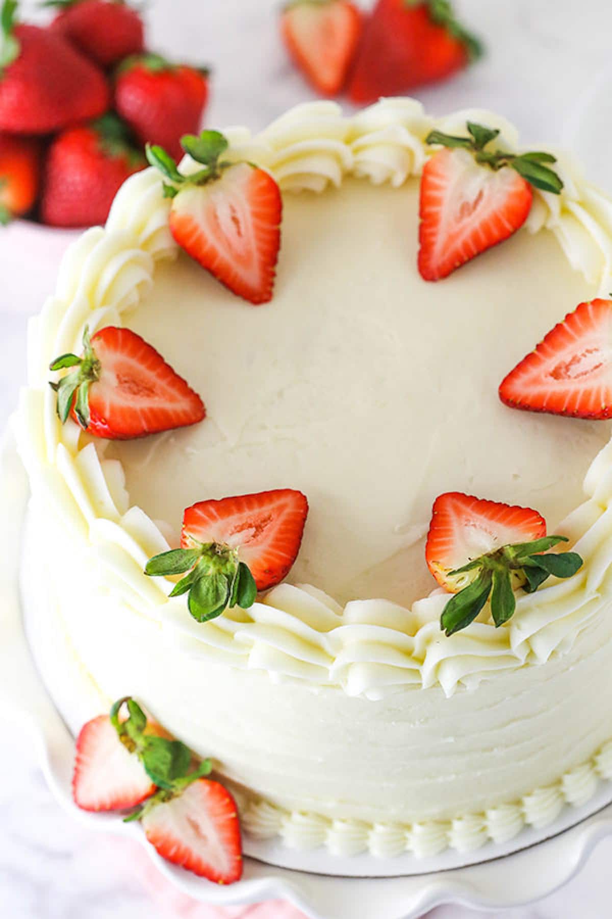 A Strawberry Layer Cake Garnished With Fresh Strawberry Slices