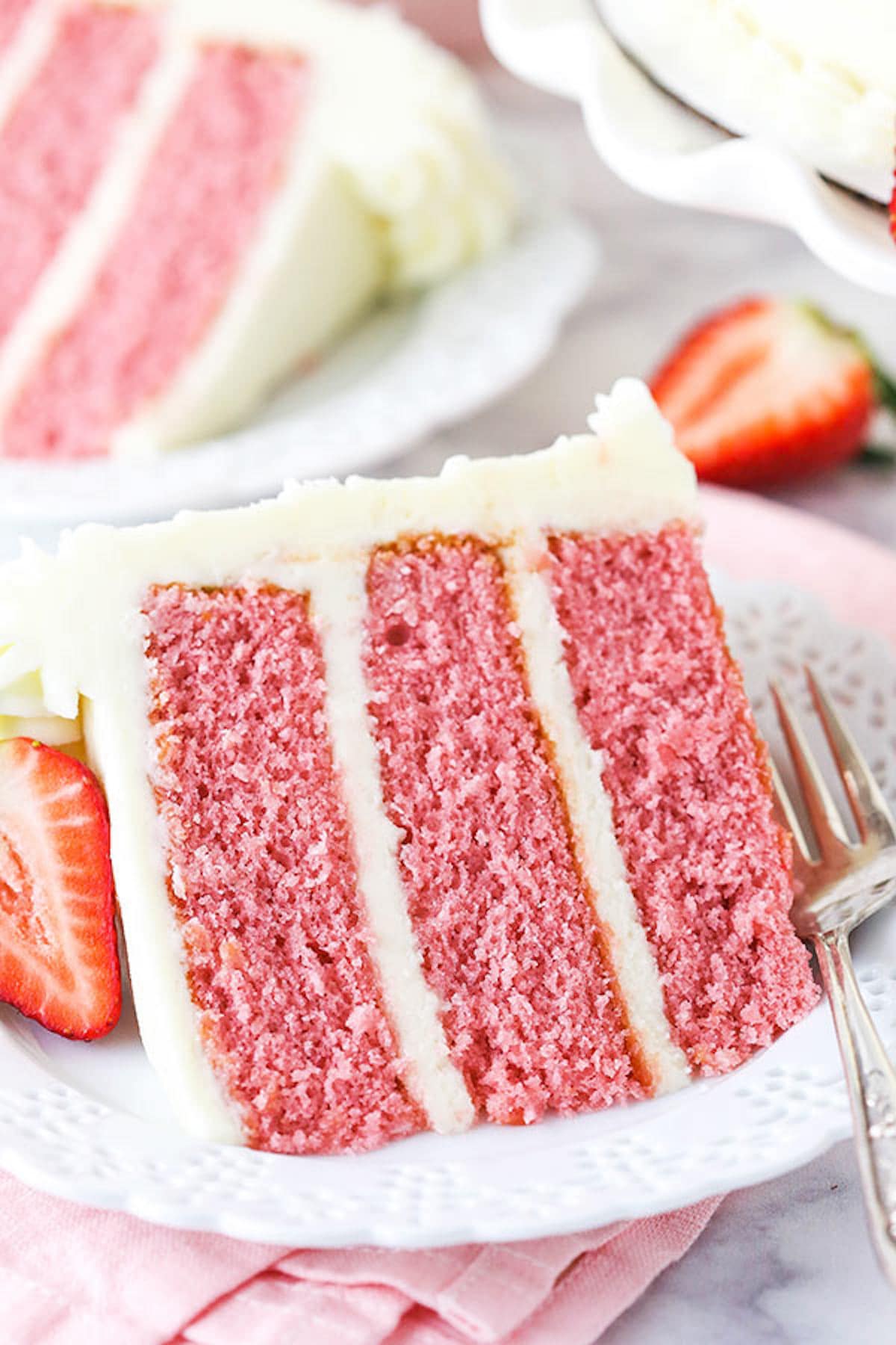 A Slice of Strawberry Cake on a White Dessert Plate