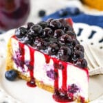 A Close-Up Shot of a Slice of Baked Blueberry Cheesecake with Blueberry Sauce on Top