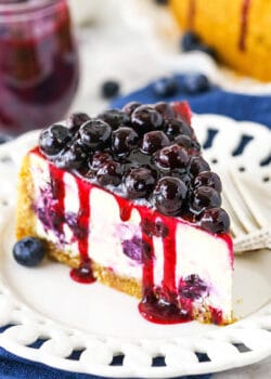 A Close-Up Shot of a Slice of Baked Blueberry Cheesecake with Blueberry Sauce on Top