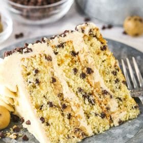 A Piece of Chocolate Chip Cake on a Plate in Front of a Bowl of Mini Chocolate Chips